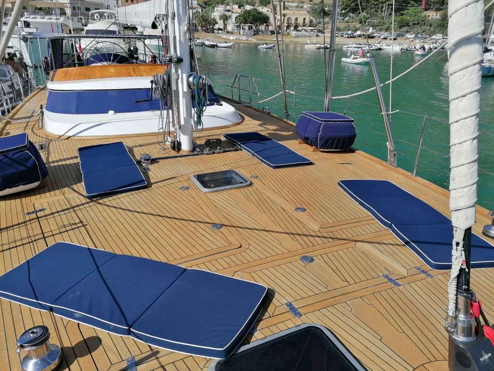 a deck with a boat and a deck with a blue tarp on it aboard MALIZIA Yacht for Sale