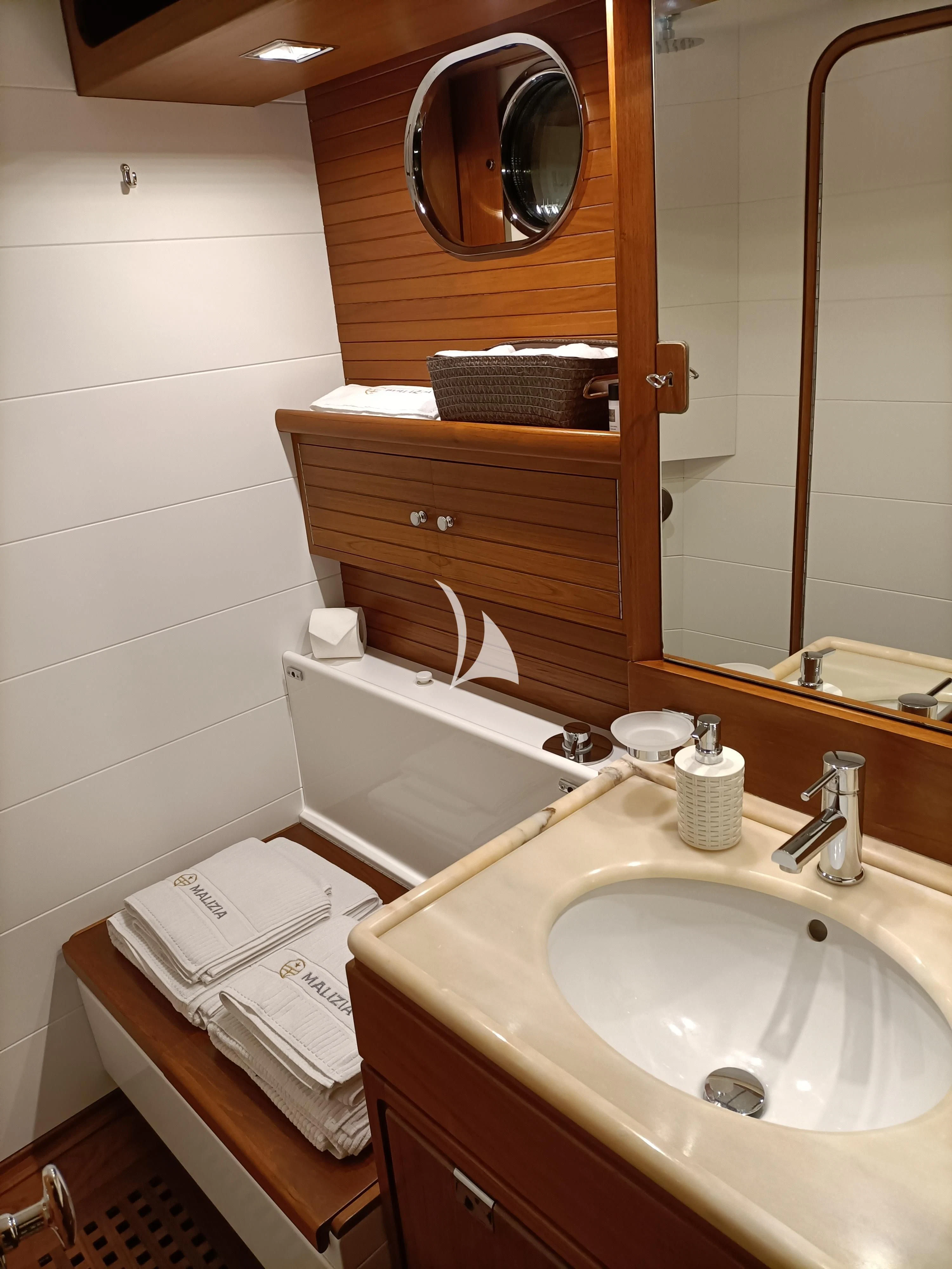 a bathroom with a mirror and a sink aboard MALIZIA Yacht for Sale