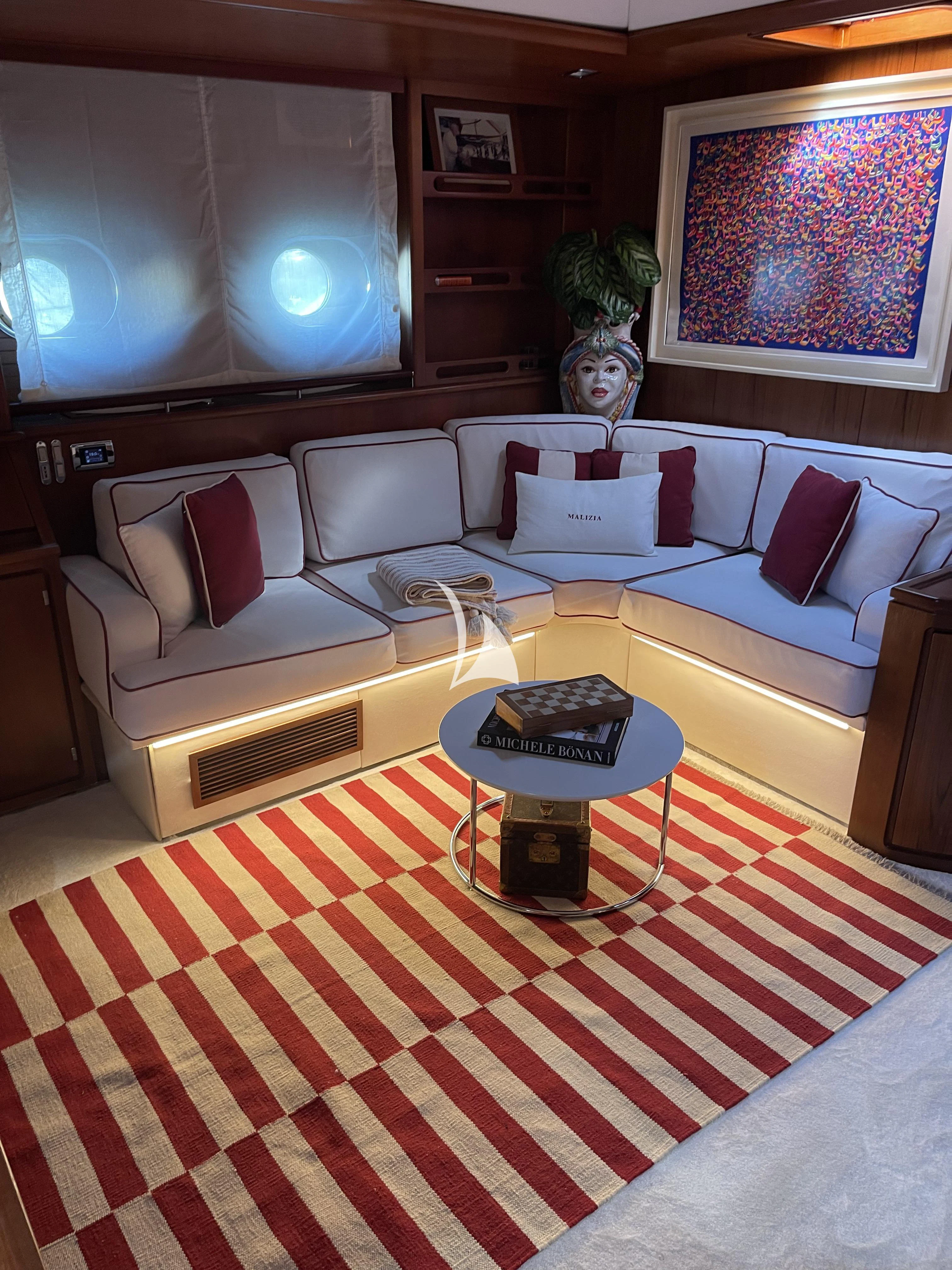 a living room with a couch and a table aboard MALIZIA Yacht for Sale