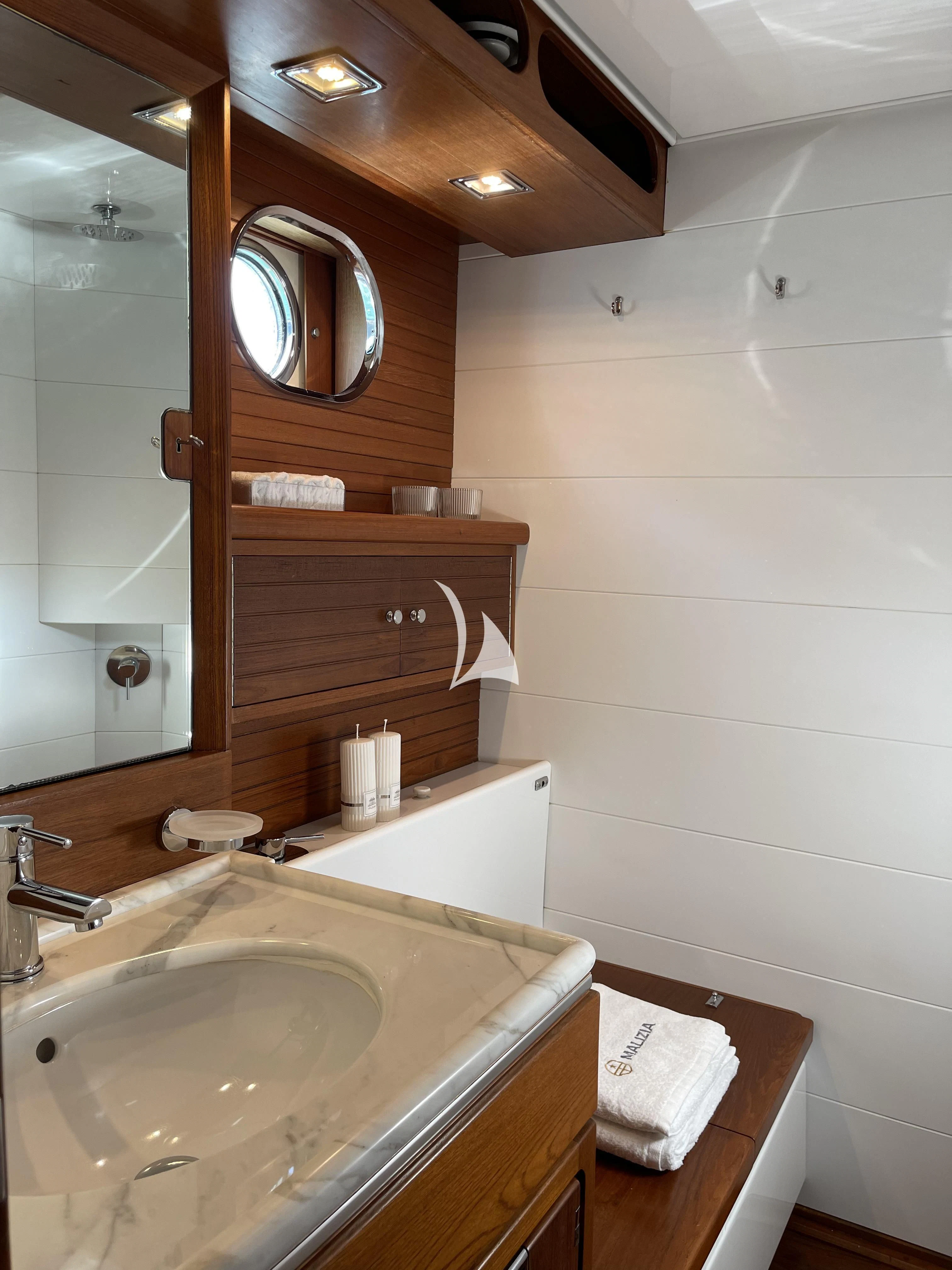 a bathroom with a sink and a mirror aboard MALIZIA Yacht for Sale