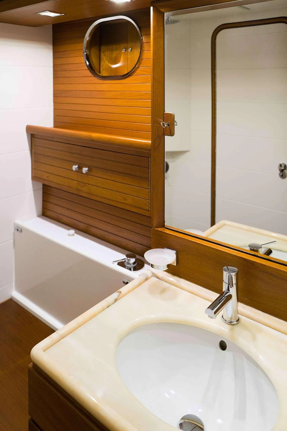 a bathroom with a mirror and a sink aboard MALIZIA Yacht for Sale