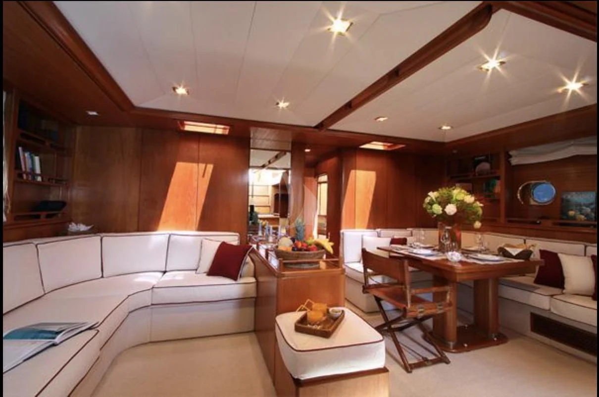 a living room with a couch and a table aboard MALIZIA Yacht for Sale