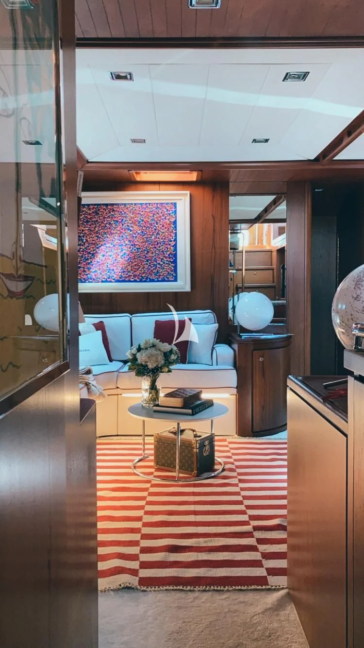 a room with a table and a chair aboard MALIZIA Yacht for Sale