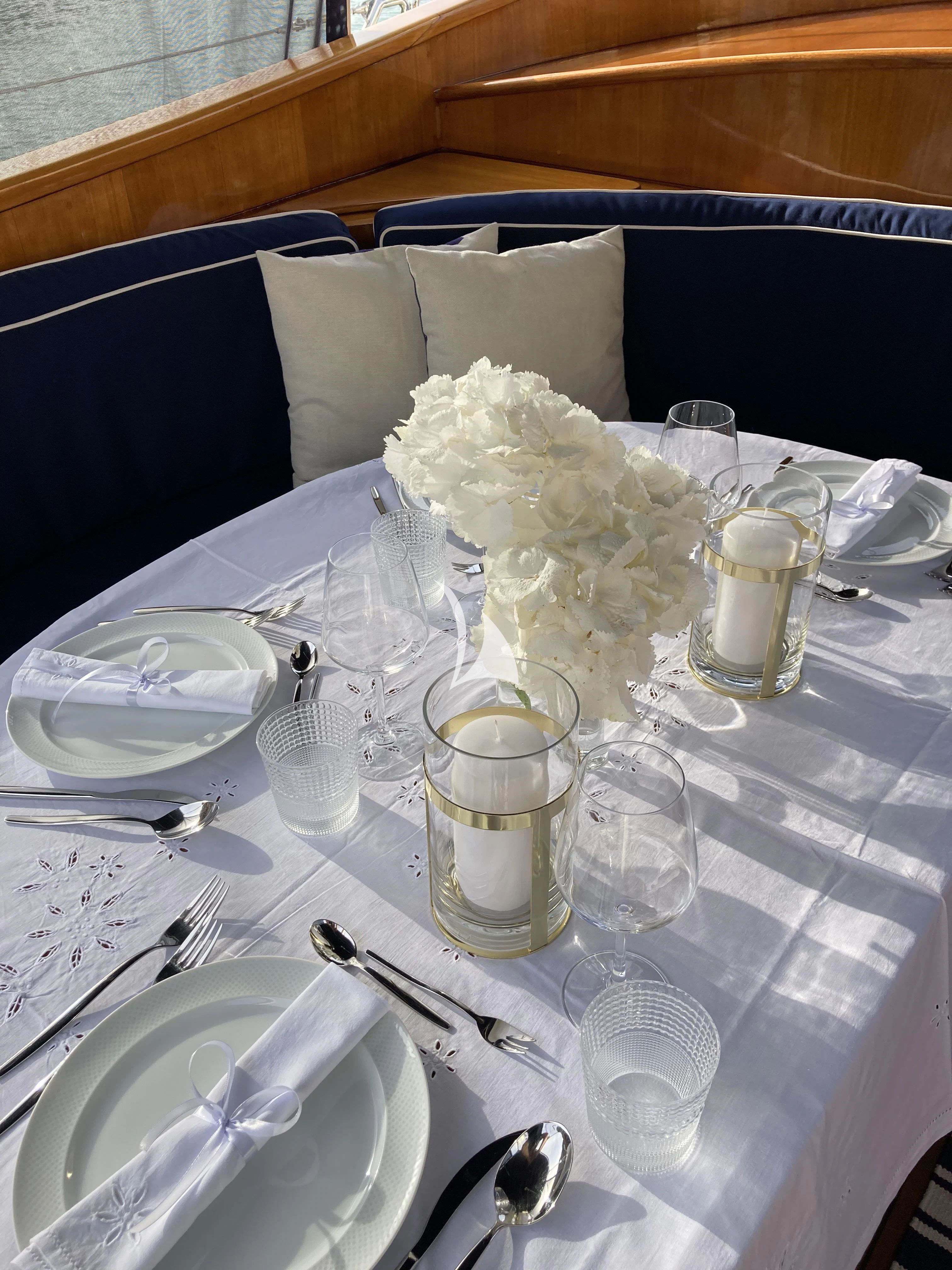 a table with a flower arrangement aboard MALIZIA Yacht for Sale