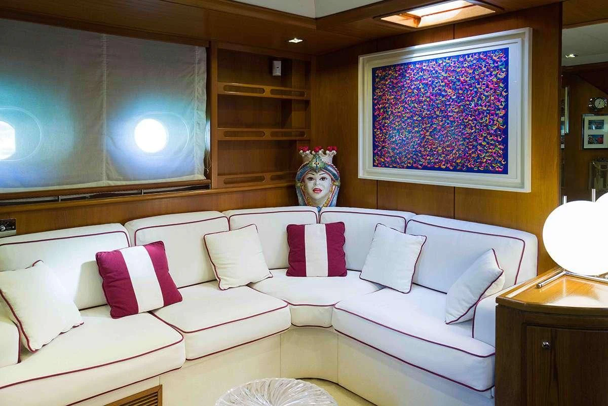 a white couch with pillows aboard MALIZIA Yacht for Sale
