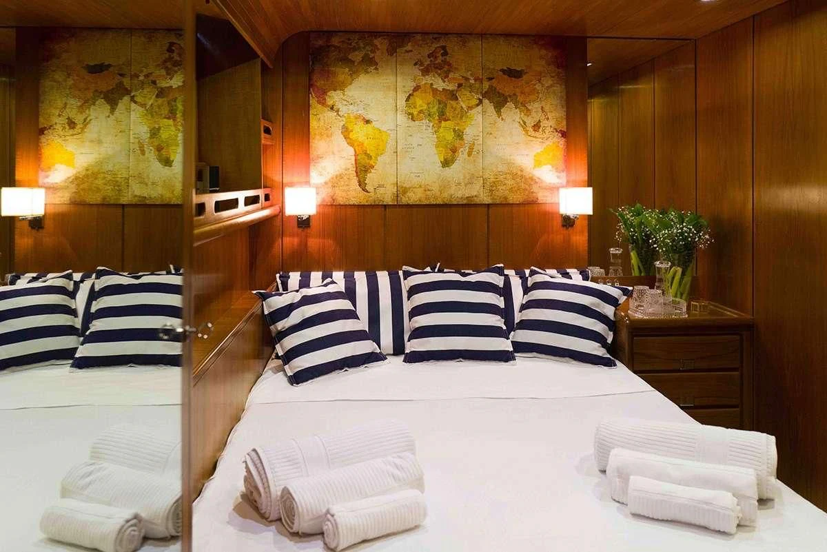 a room with a bed and a desk aboard MALIZIA Yacht for Sale