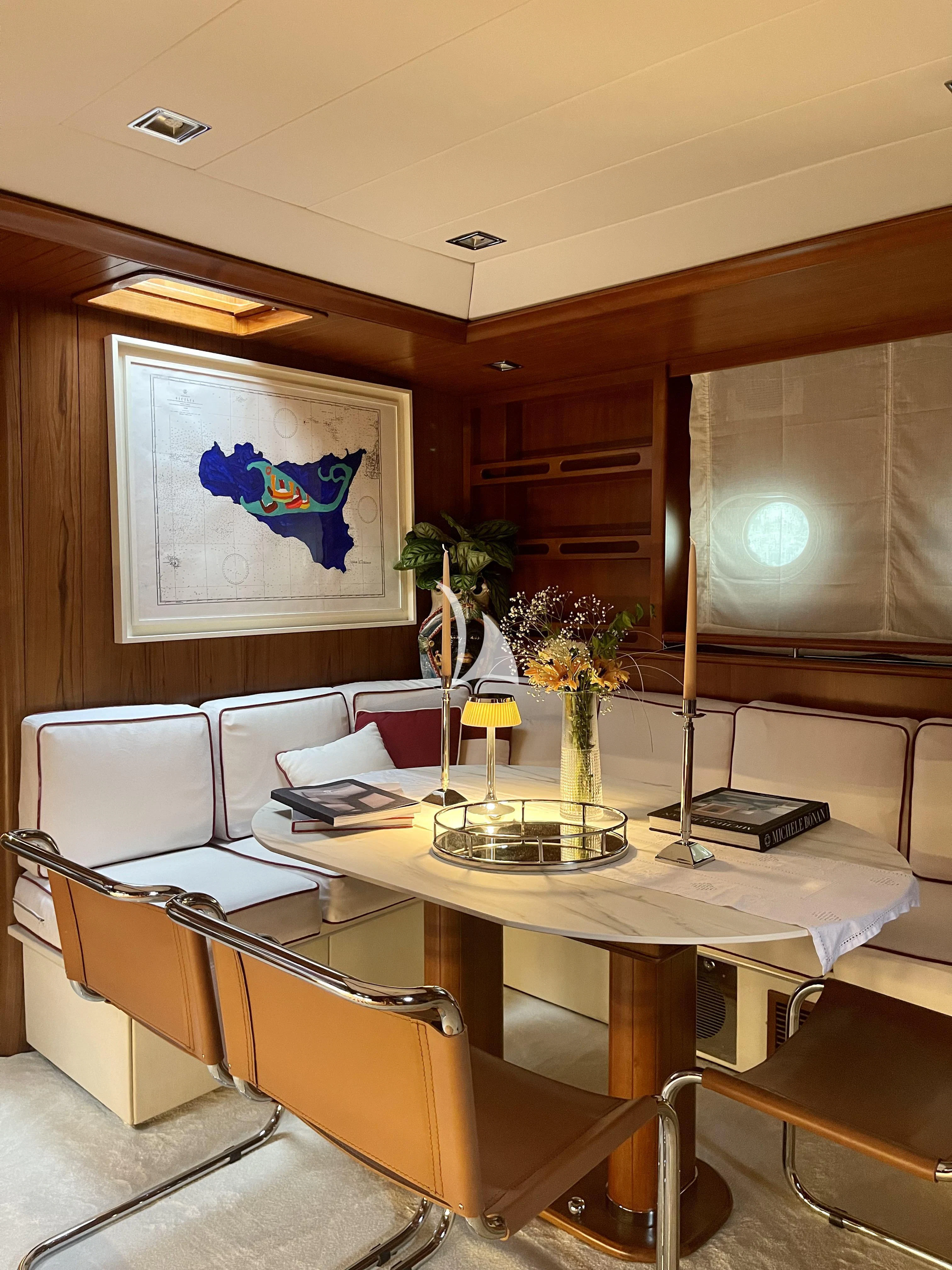 a room with a table and chairs aboard MALIZIA Yacht for Sale