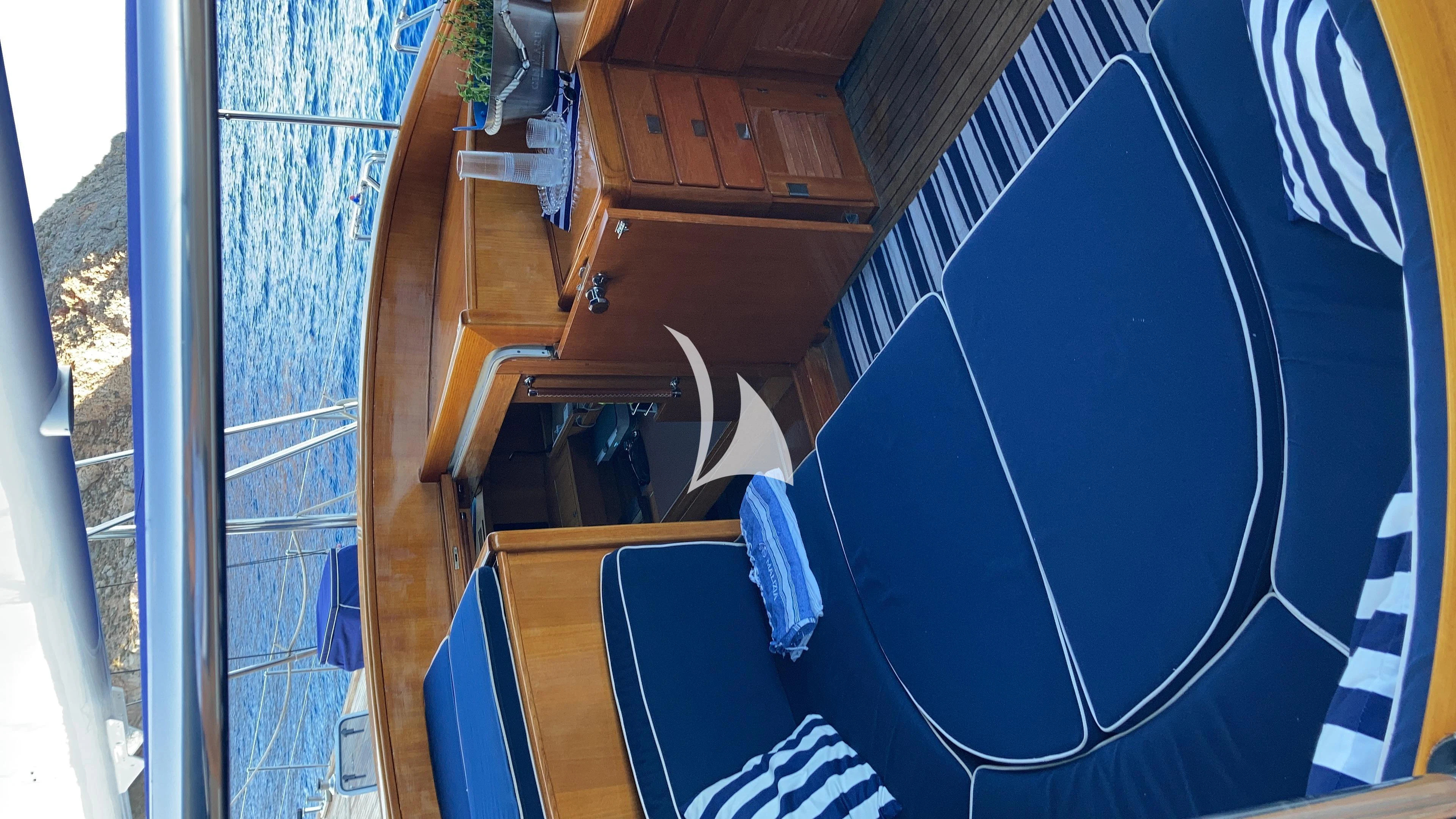 a boat with a blue canopy aboard MALIZIA Yacht for Sale