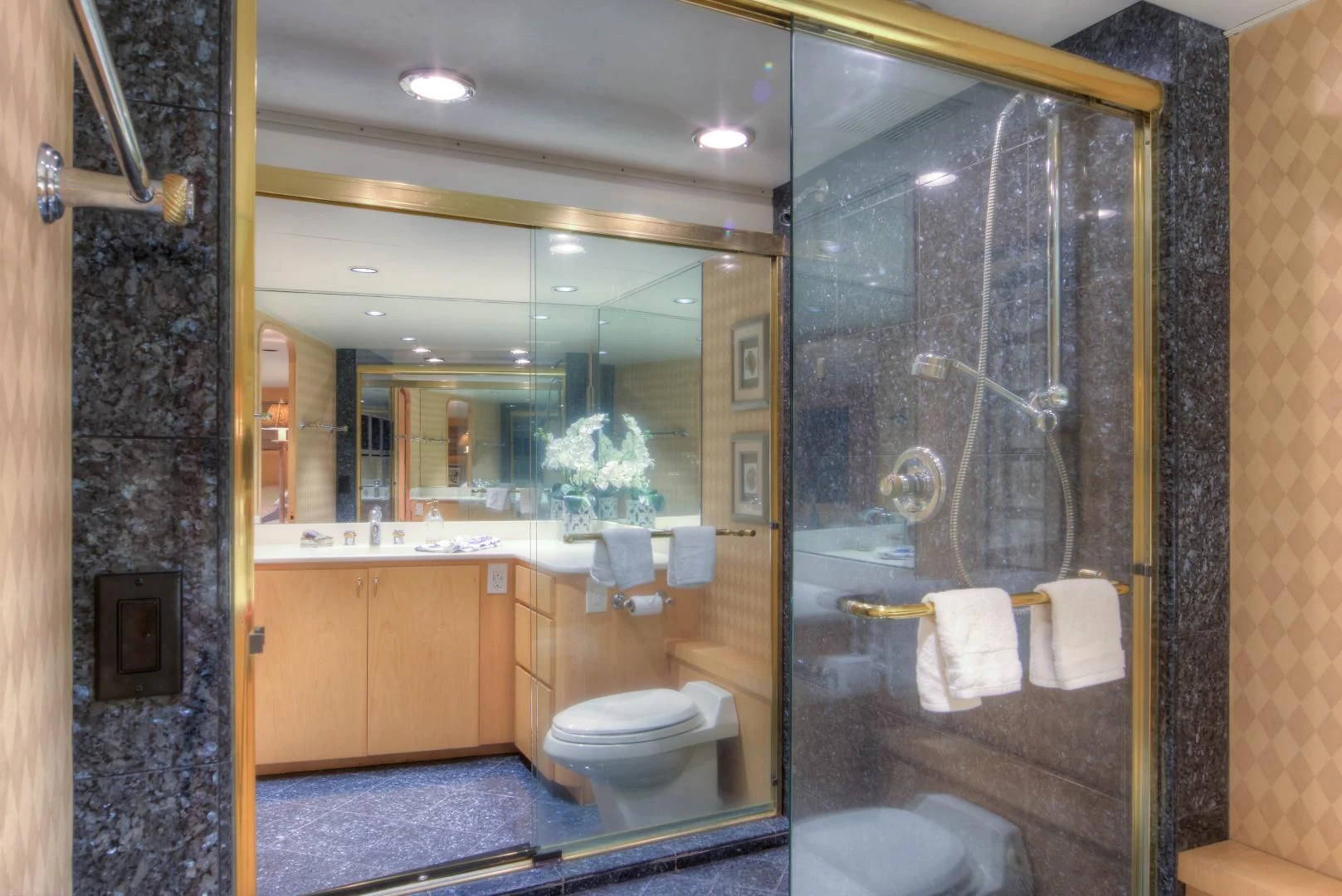a bathroom with a glass shower aboard LADY LEX Yacht for Sale