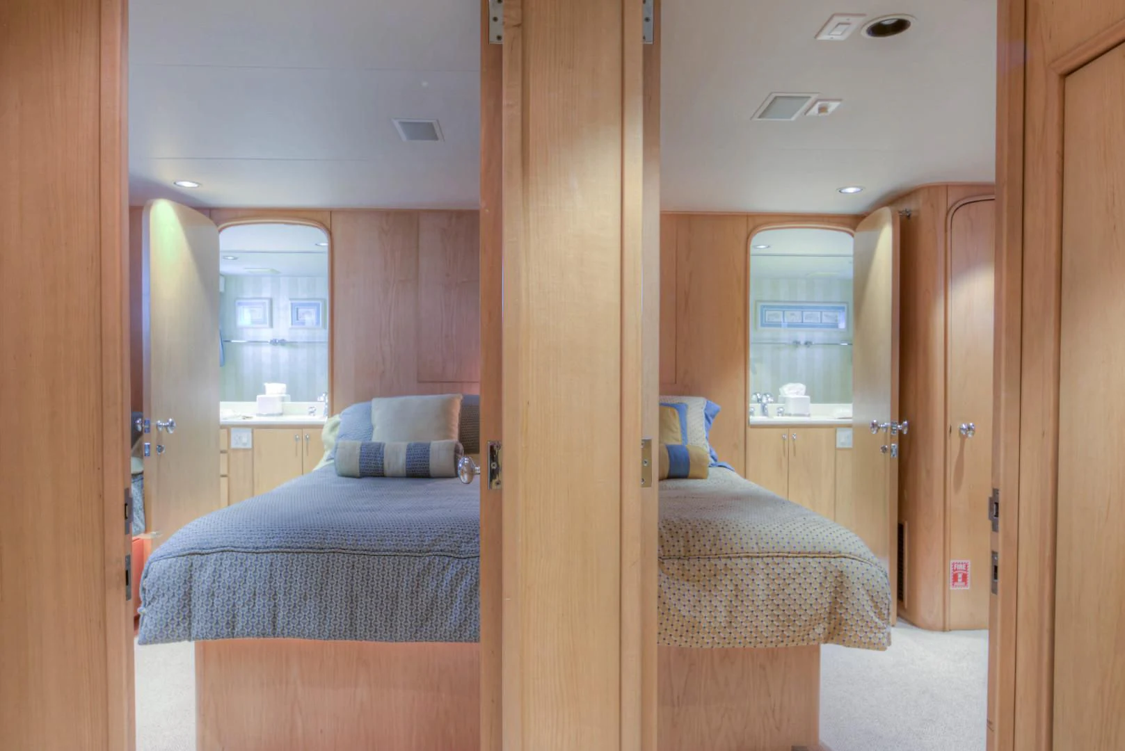 a room with a bed and a door aboard LADY LEX Yacht for Sale