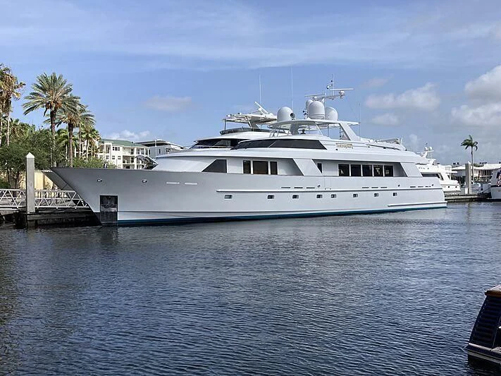 a white yacht docked at a dock aboard UKARA Yacht for Sale