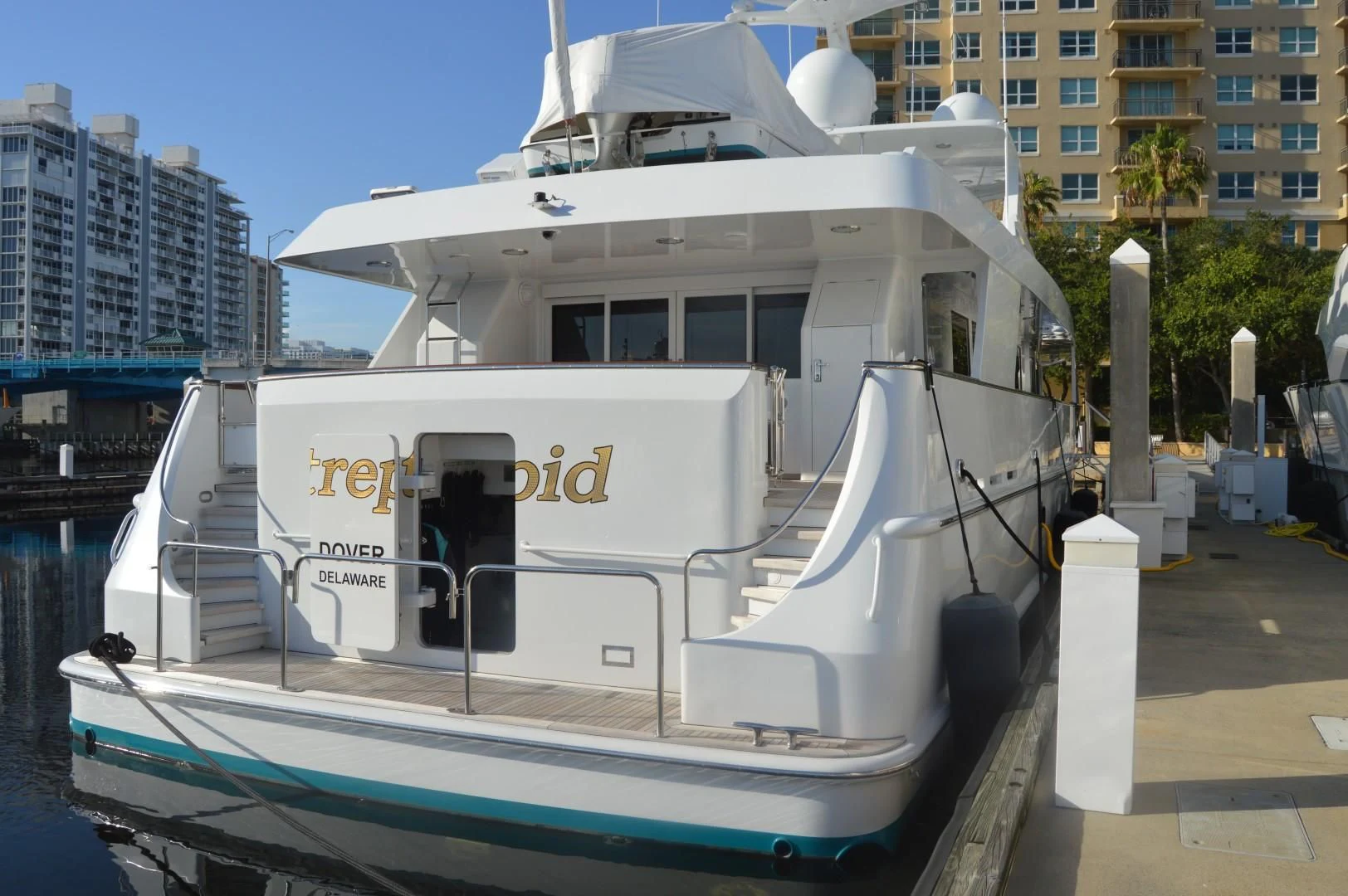 a large white boat in a dock aboard UKARA Yacht for Sale