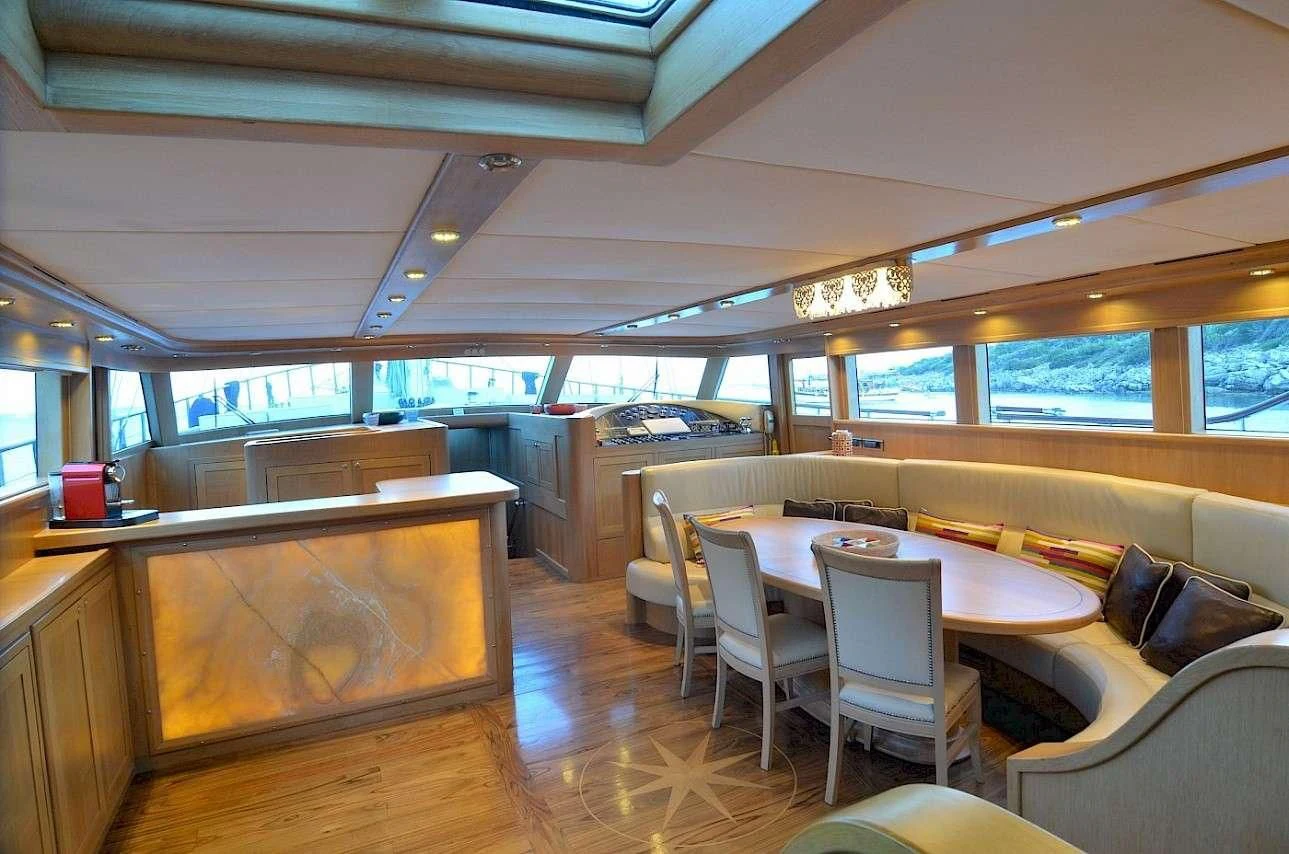 a room with a table and chairs aboard BLUE HEAVEN Yacht for Charter