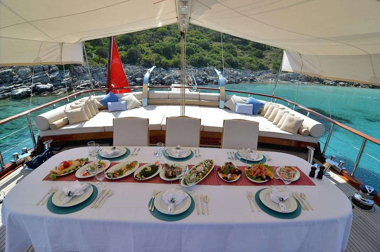 a large white tent with a table set for a meal aboard BLUE HEAVEN Yacht for Charter