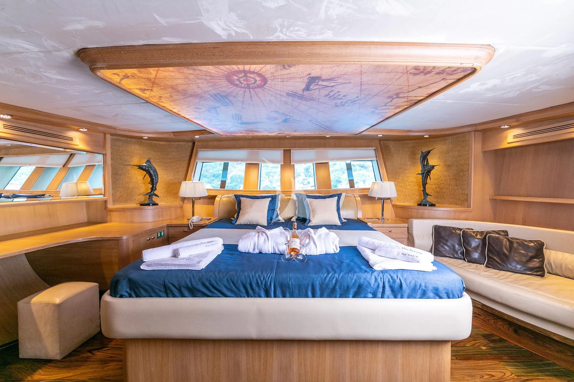a room with a bed and a couch aboard BLUE HEAVEN Yacht for Charter