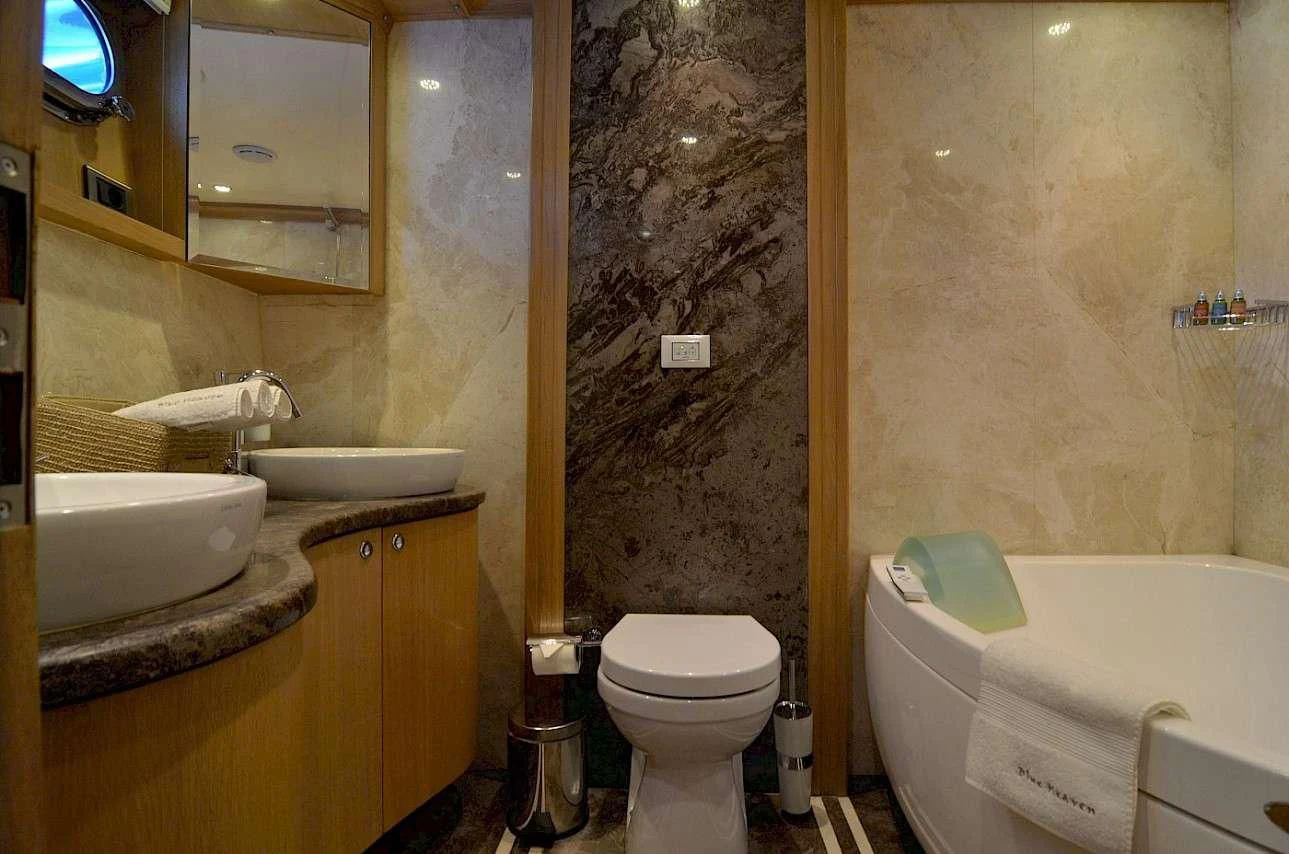 a bathroom with a toilet and sink aboard BLUE HEAVEN Yacht for Charter