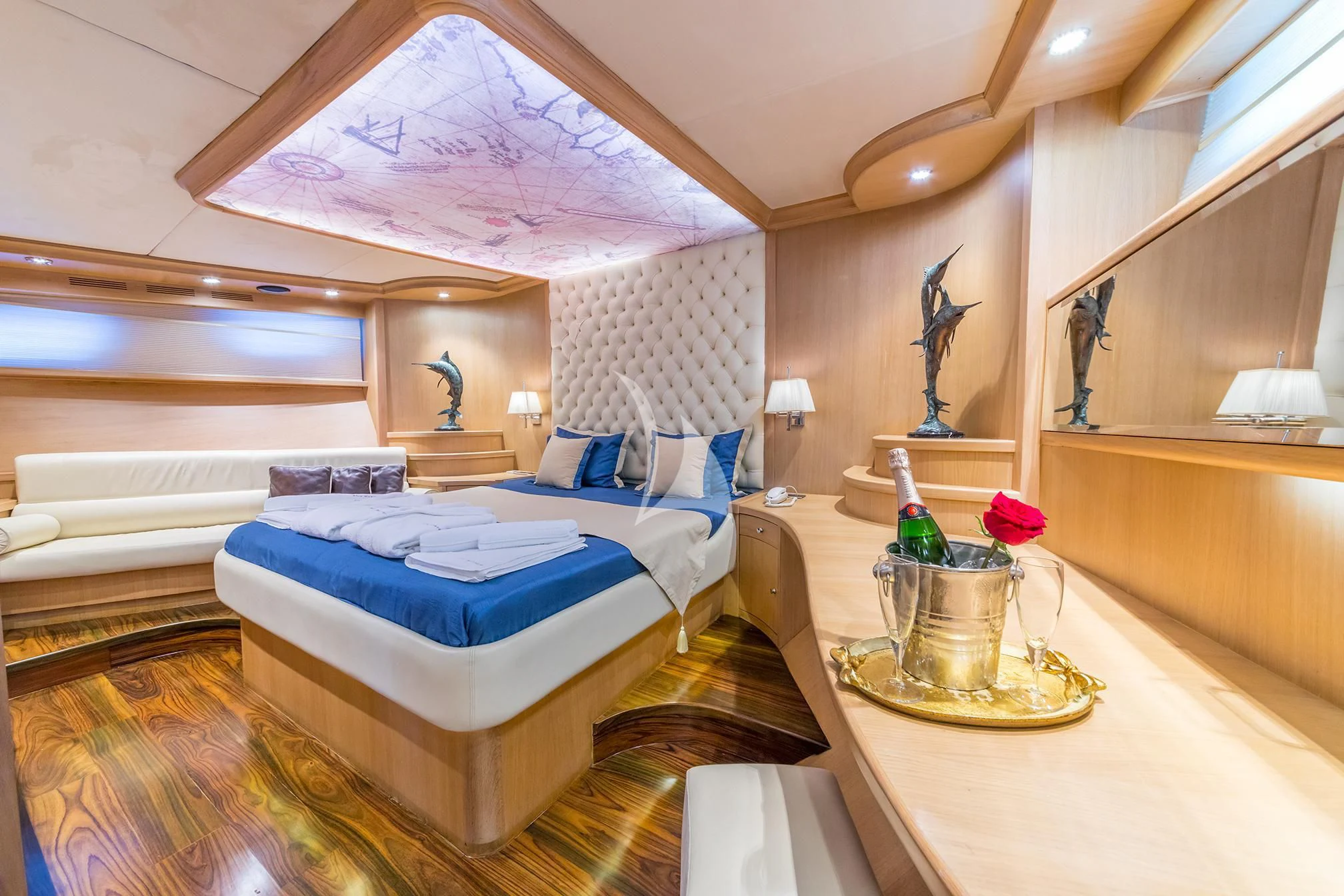a room with a bed and a table aboard BLUE HEAVEN Yacht for Charter