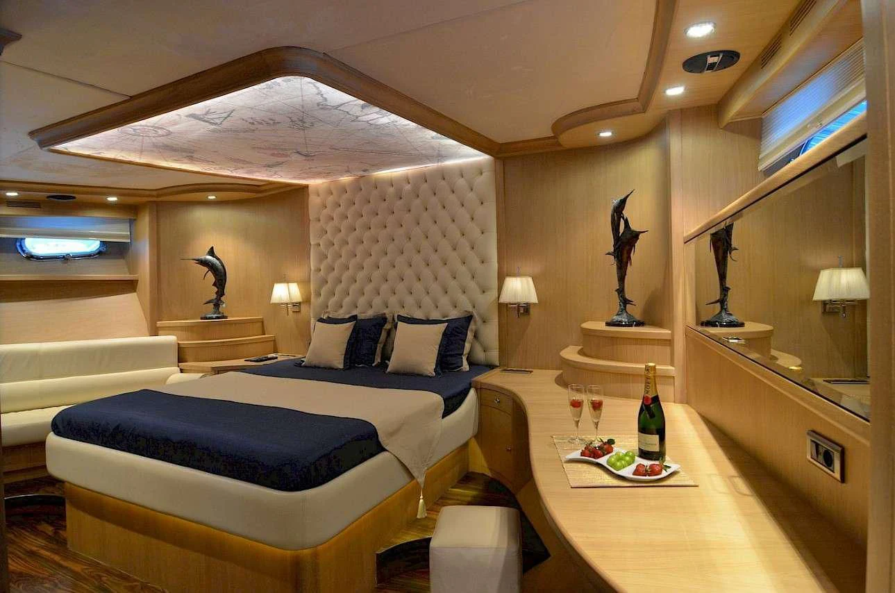 a room with a bed and a table aboard BLUE HEAVEN Yacht for Charter