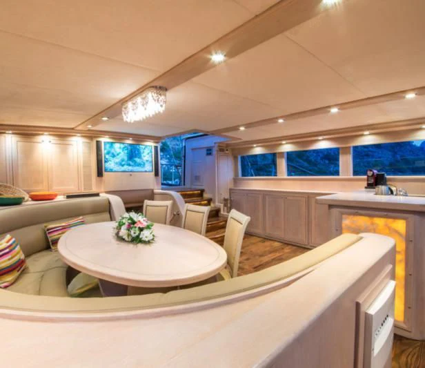 a kitchen with a table and chairs aboard BLUE HEAVEN Yacht for Charter