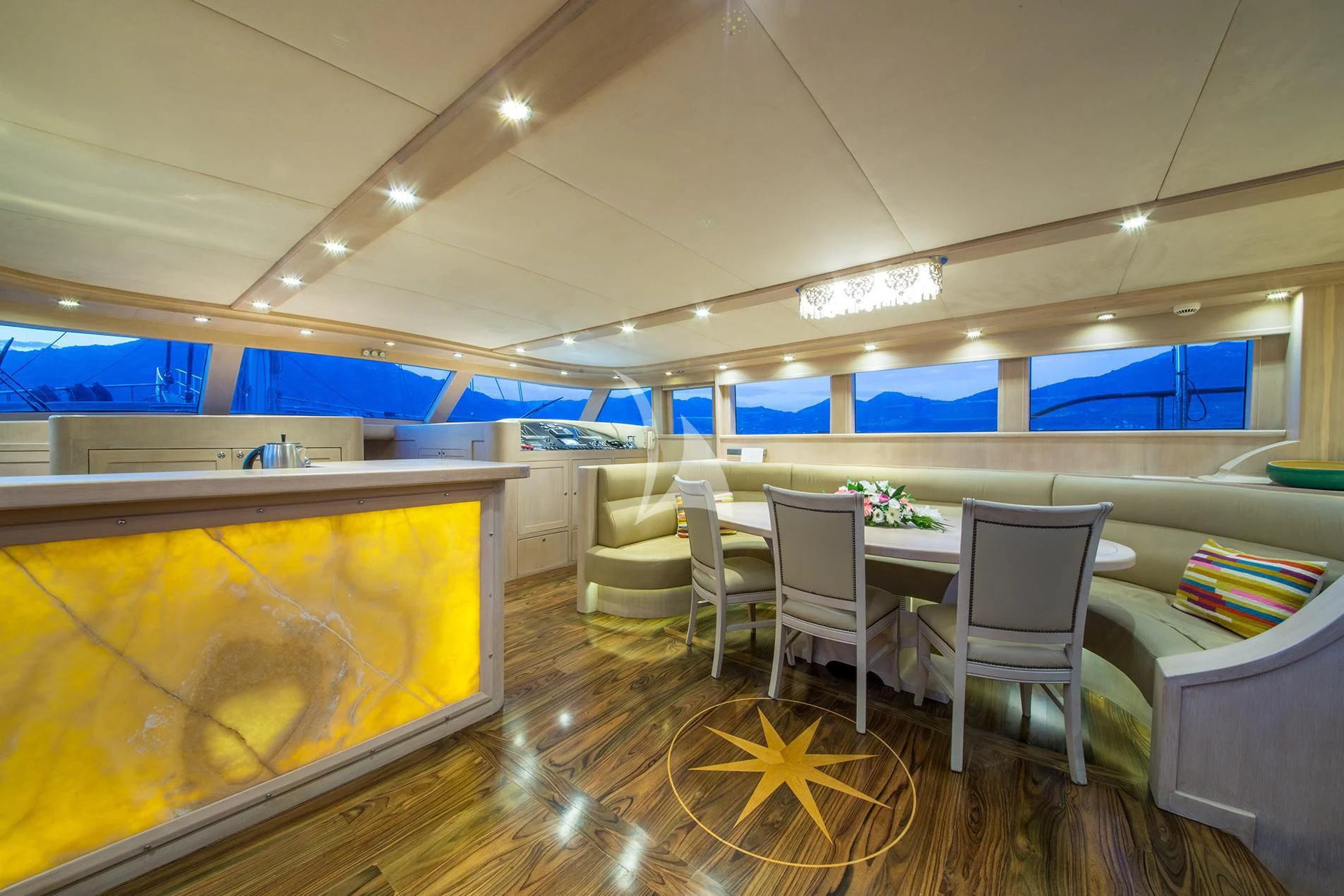 a room with tables and chairs aboard BLUE HEAVEN Yacht for Charter