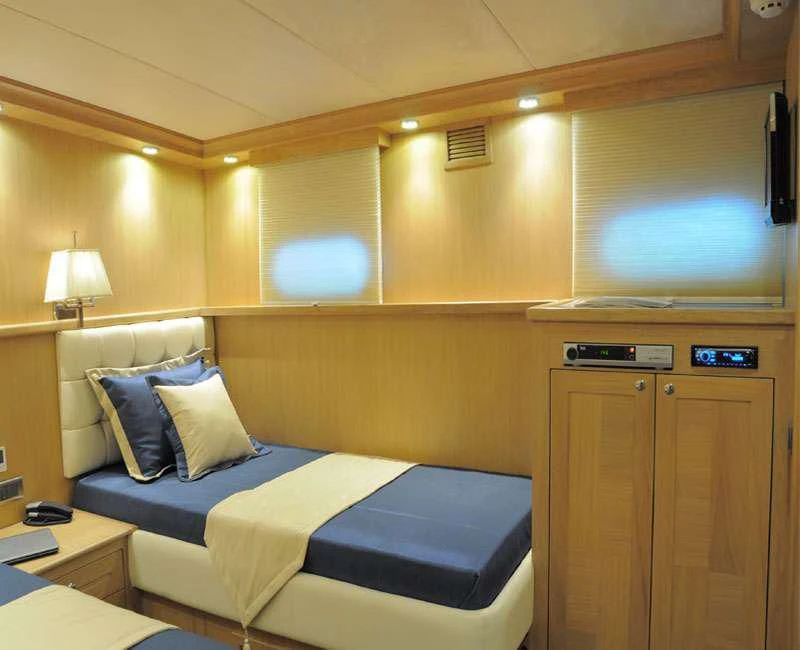 a hotel room with a bed and a tv aboard BLUE HEAVEN Yacht for Charter
