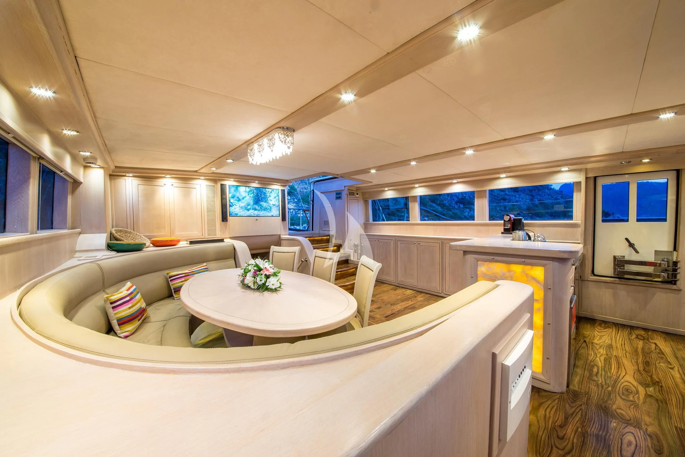 a large white kitchen with a large white counter and a large window aboard BLUE HEAVEN Yacht for Charter