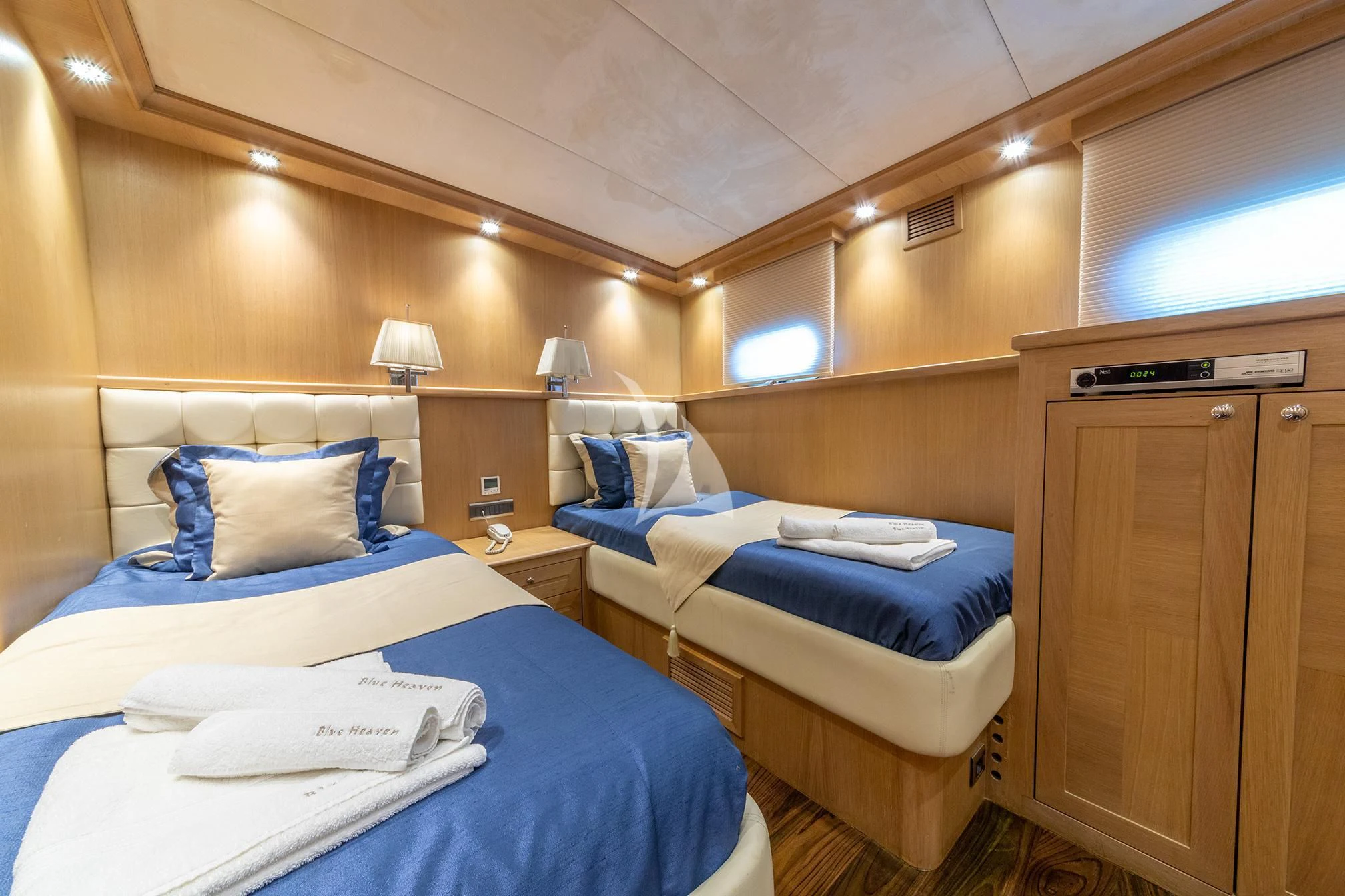 a room with beds and a cabinet aboard BLUE HEAVEN Yacht for Charter
