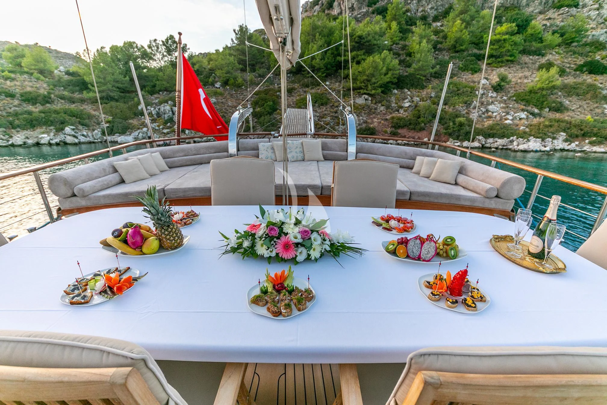 a table with flowers and decorations aboard BLUE HEAVEN Yacht for Charter