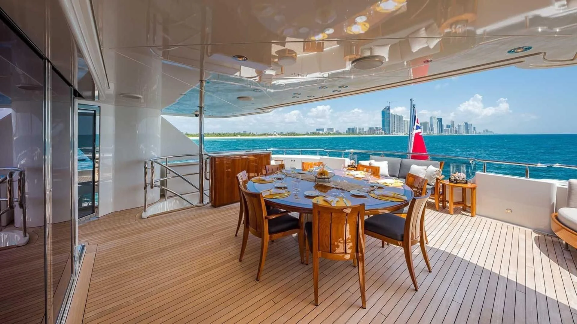 a table and chairs on a deck overlooking a city aboard AS YOU WISH Yacht for Sale