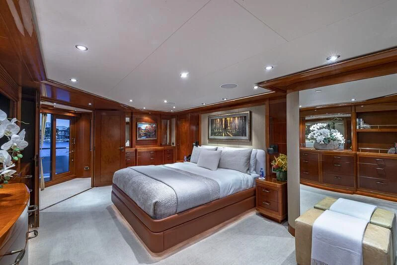 a bedroom with a bed and a mirror aboard AS YOU WISH Yacht for Sale