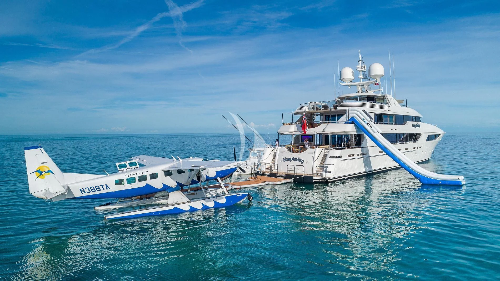 a couple of large white boats in the water aboard AS YOU WISH Yacht for Sale