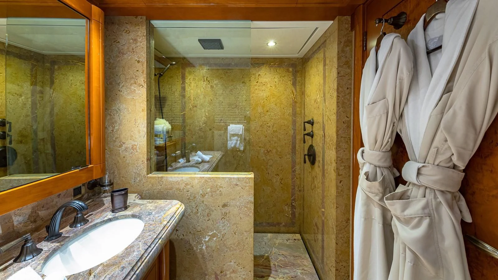 a bathroom with a robe on the wall aboard AS YOU WISH Yacht for Sale
