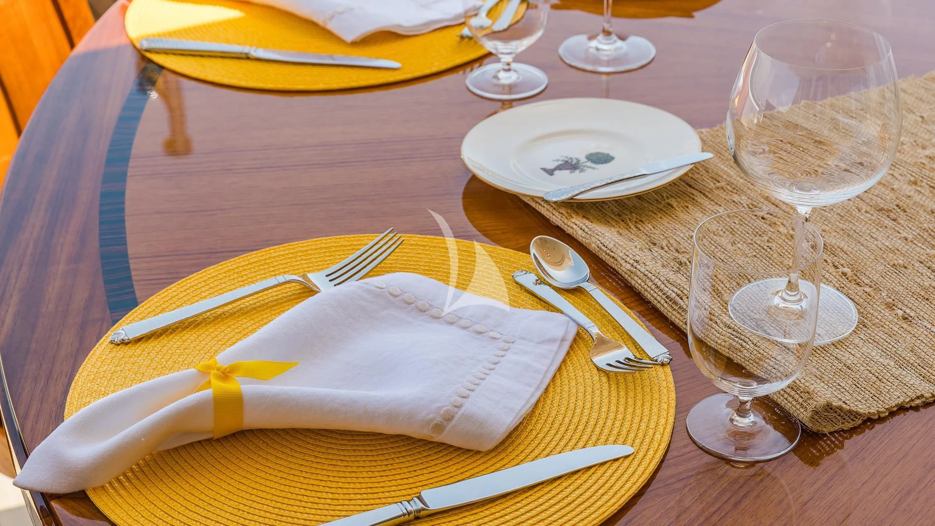 a table with plates and silverware aboard AS YOU WISH Yacht for Sale