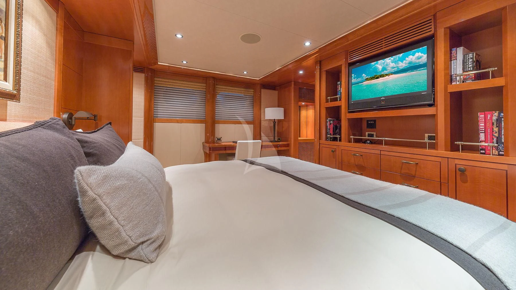 a bed with pillows and a television in a room aboard AS YOU WISH Yacht for Sale