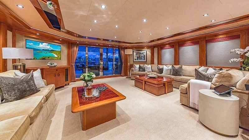 a living room with a large sofa and a coffee table aboard AS YOU WISH Yacht for Sale