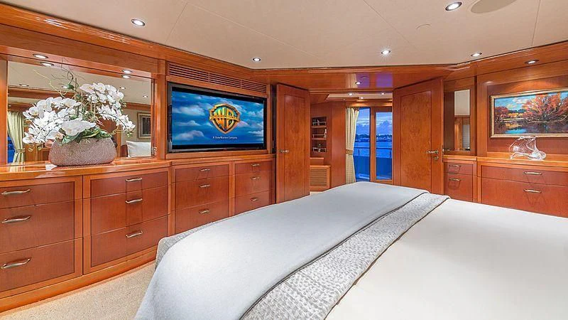 a bedroom with a bed and a television aboard AS YOU WISH Yacht for Sale