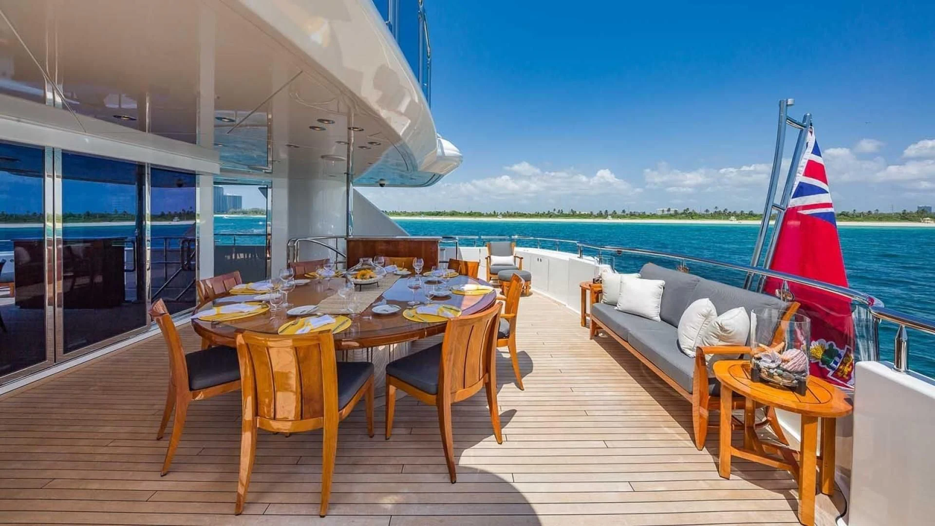 a deck with a table and chairs on it aboard AS YOU WISH Yacht for Sale