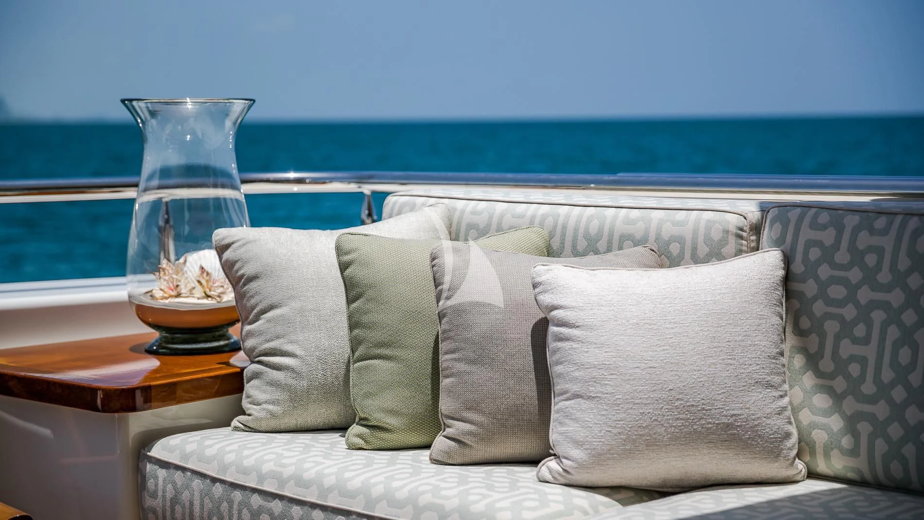 a glass of water next to a bed with pillows and pillows aboard AS YOU WISH Yacht for Sale
