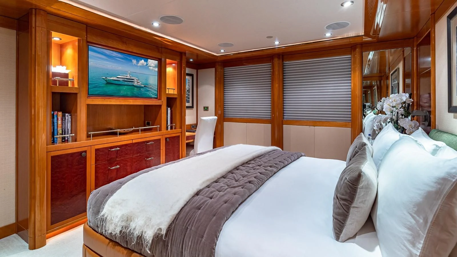 a bedroom with a bed and a tv on the wall aboard AS YOU WISH Yacht for Sale