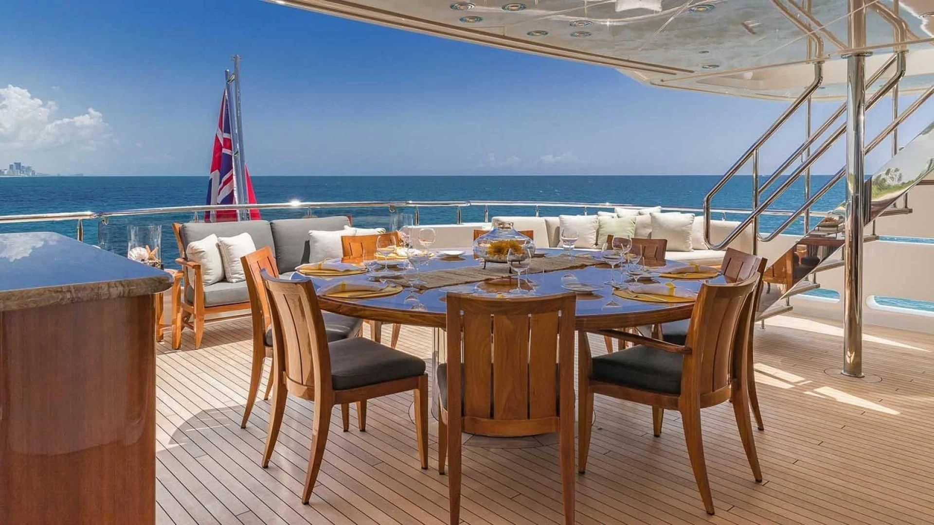 a table set for a meal on a deck overlooking the ocean aboard AS YOU WISH Yacht for Sale
