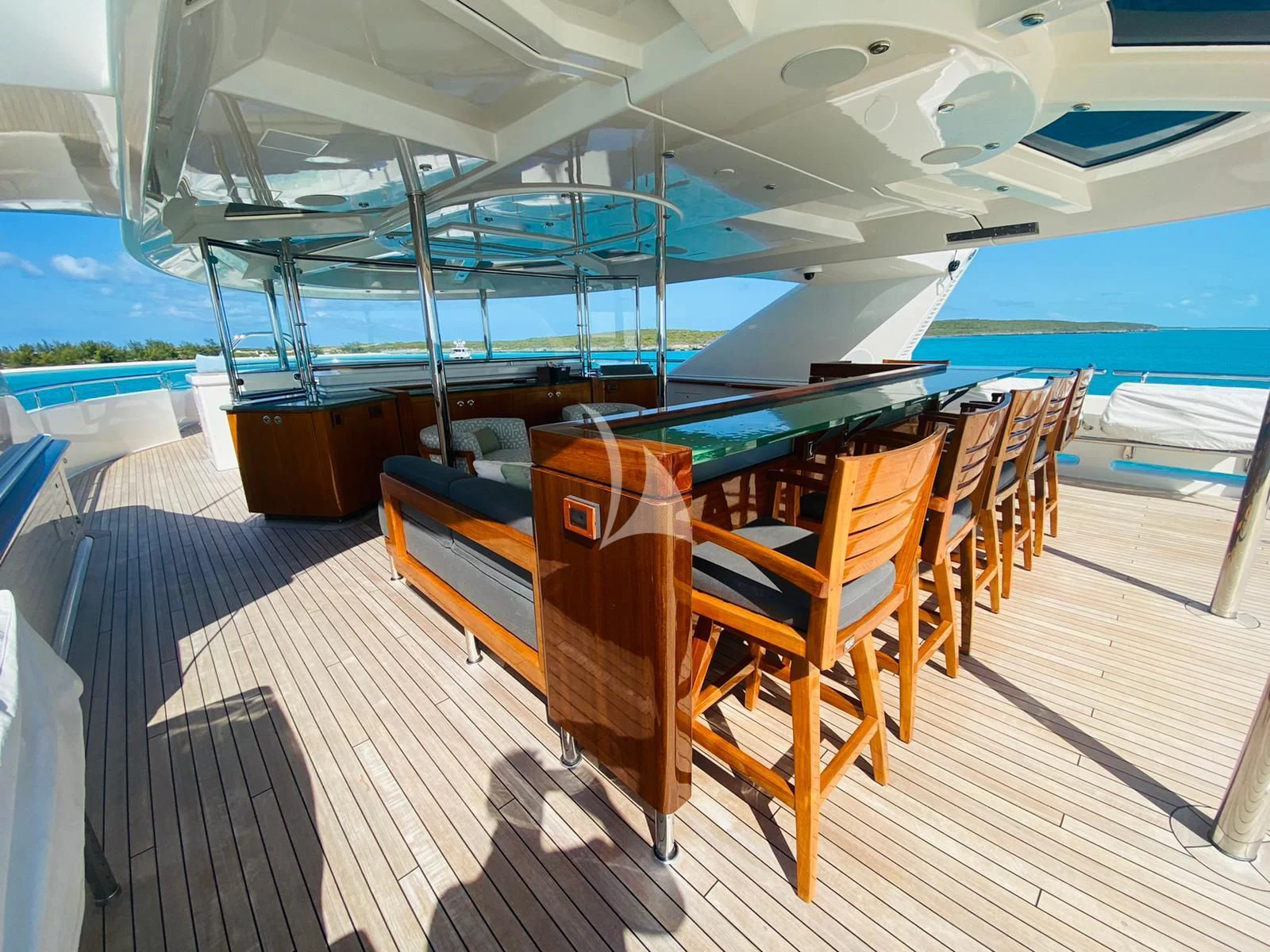 a pool table and chairs in a room with a pool and a deck aboard AS YOU WISH Yacht for Sale