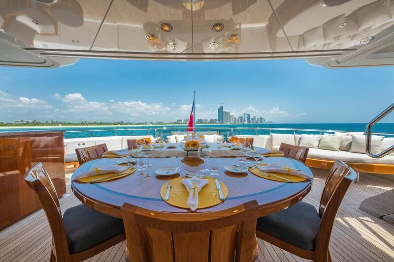 a table set for a meal on a balcony overlooking the ocean aboard AS YOU WISH Yacht for Sale