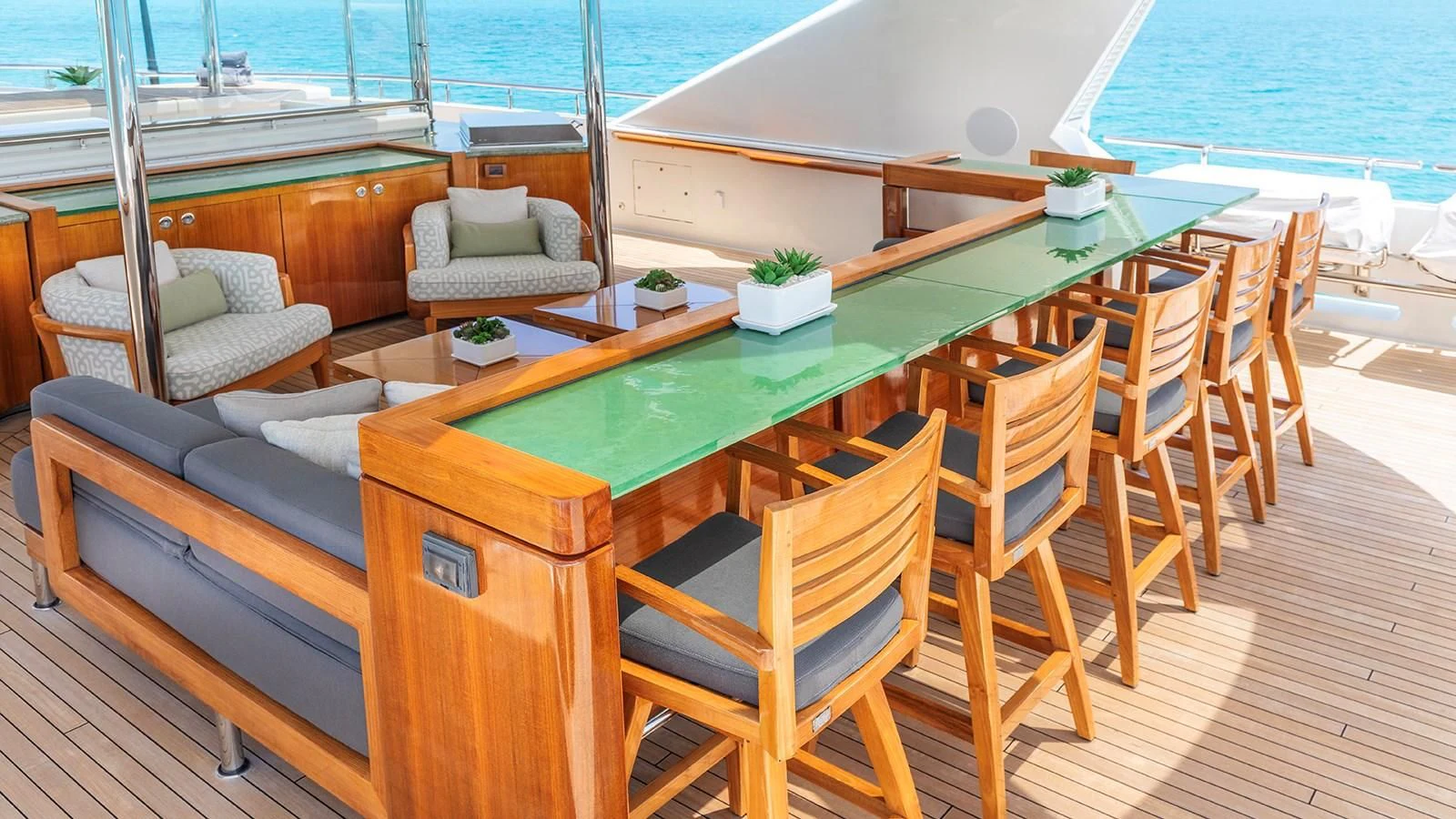 a deck with a table and chairs on it aboard AS YOU WISH Yacht for Sale
