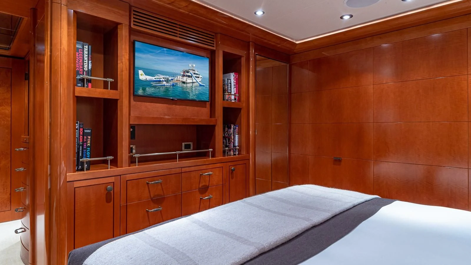 a room with a bed and a tv on the wall aboard AS YOU WISH Yacht for Sale