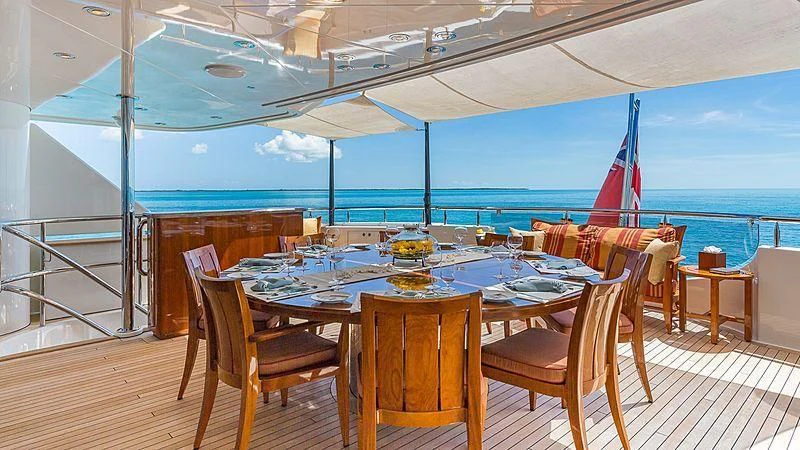 a table set for a meal on a deck aboard AS YOU WISH Yacht for Sale