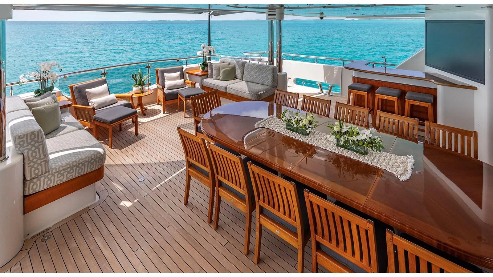 a room with a table chairs and a tv on the wall aboard AS YOU WISH Yacht for Sale