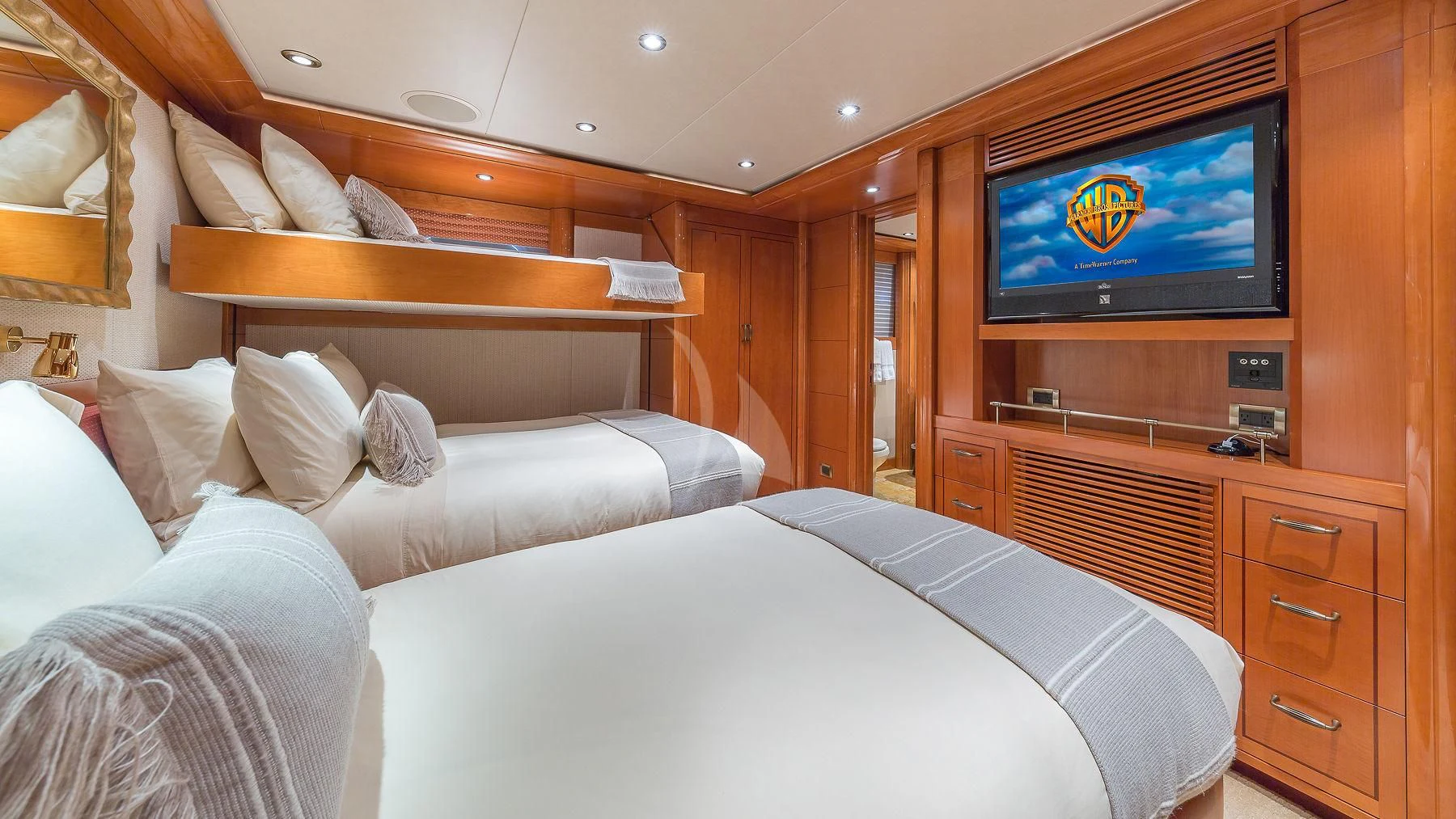 a bed with a tv on the wall aboard AS YOU WISH Yacht for Sale