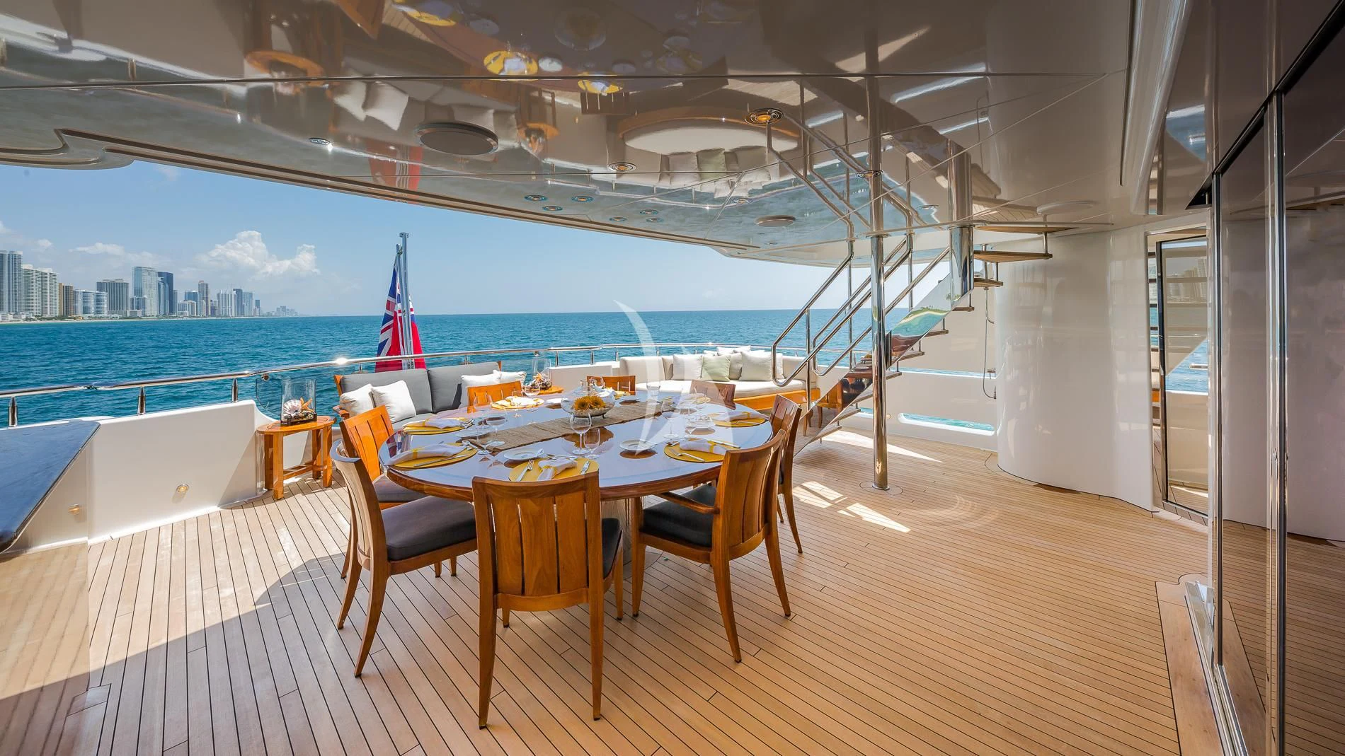a table set for a meal on a deck overlooking a city aboard AS YOU WISH Yacht for Sale