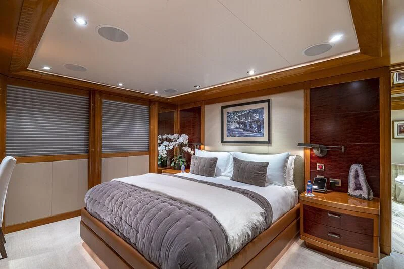 a bedroom with a bed and a dresser aboard AS YOU WISH Yacht for Sale