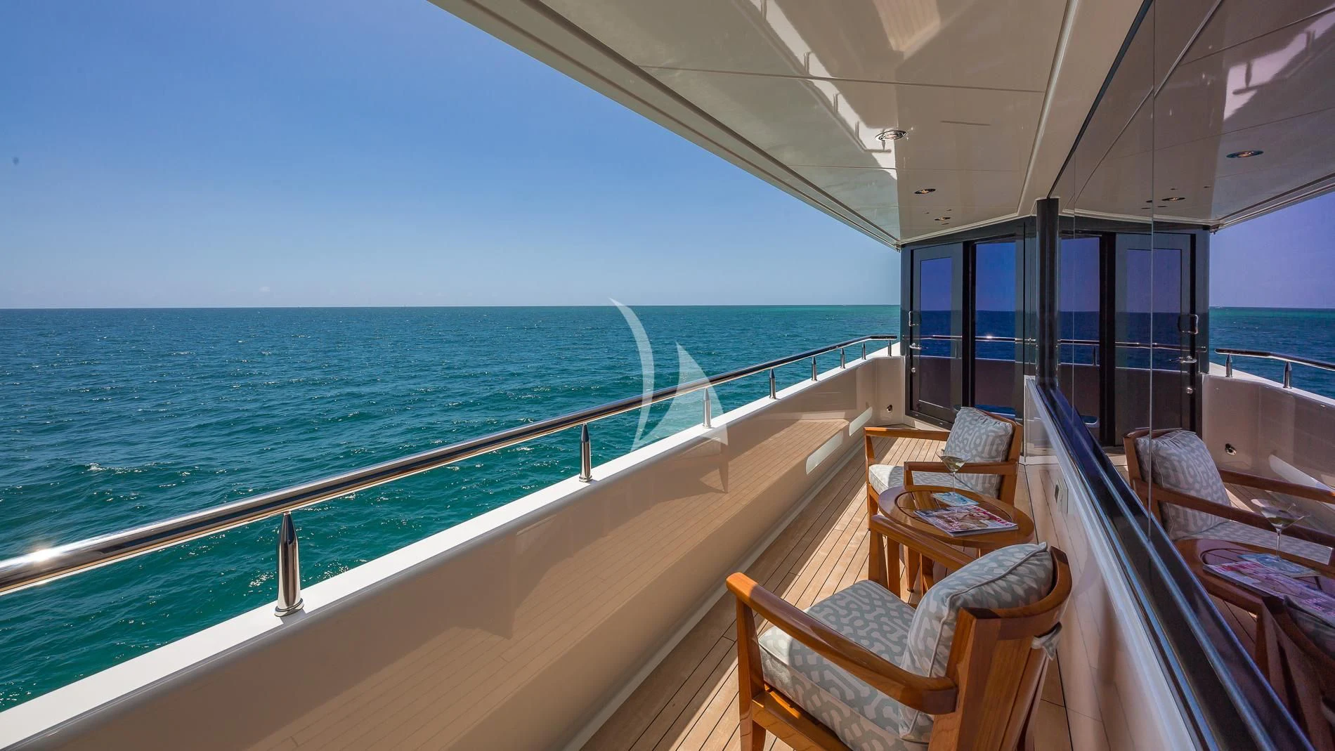 a deck with chairs and a table on it aboard AS YOU WISH Yacht for Sale